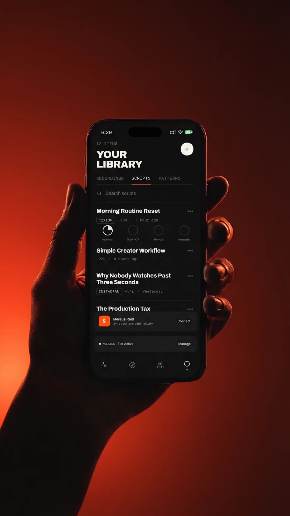 A hand holding the Megaphone app against a red background